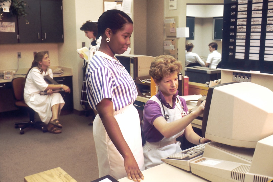 Nurses working at computer terminals in a hospital nurses station, representing how healthcare organizations are deploying secure on-premise AI systems for clinical and administrative workflows